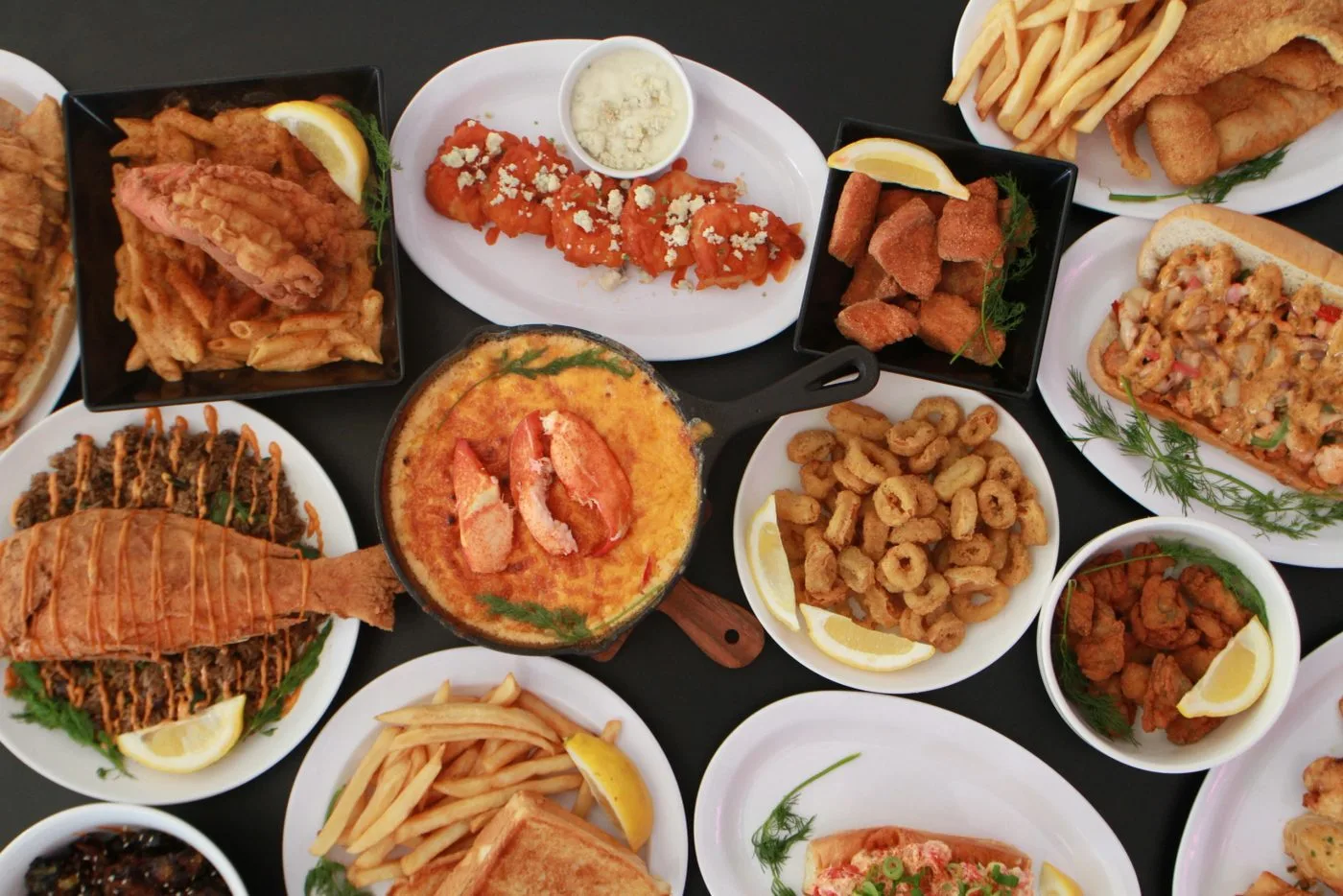 A table of Shellfish Market seafood, lobster, shrimp and fried fish
